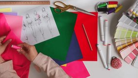 A creative workspace for fashion designers featuring sketches, fabrics, and tools essential for crafting unique styles. Atelier, design and tailoring concept. - Powered by Shutterstock - Get 15% off with code: PIKWIZARD15