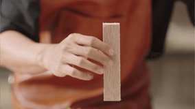 Jakarta - INDONESIA, 5-Jan-2025: Close-up of a hand placing a wooden block on an architectural scale model with miniature buildings and green plants, representing urban planning and design concepts. - Powered by Shutterstock - Get 15% off with code: PIKWIZARD15