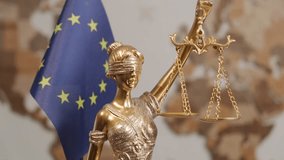Themis statue with scales of justice with European Union flag on background of world map - Powered by Shutterstock - Get 15% off with code: PIKWIZARD15