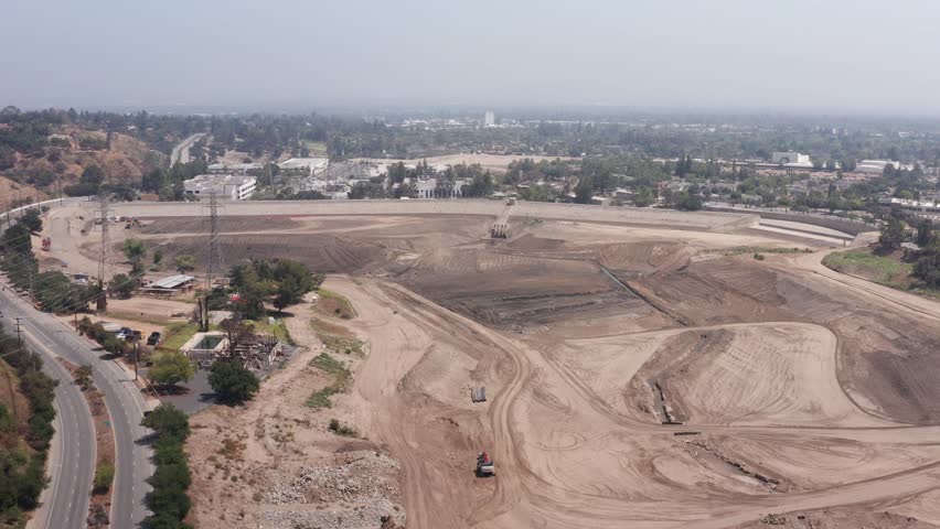 Wide panning aerial shot of Eaton Canyon Reservoir after the Los Angeles Fires in Altadena, California. 4K