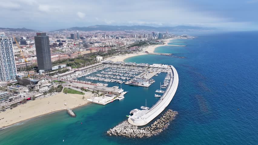 Port Of Barcelona At Barcelona In Catalonia Spain. Urban Beach. Bay Water Scenery. Downtown City. Port Of Barcelona At Barcelona In Catalonia Spain. Peaceful Landscape.