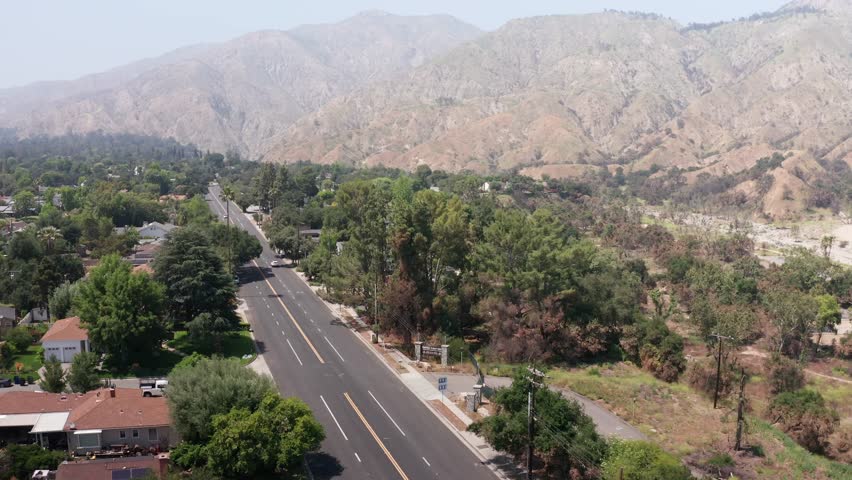 Aerial descending and panning shot of the Eaton Canyon park entrance signage after the wildfire in Altadena, California. 4K