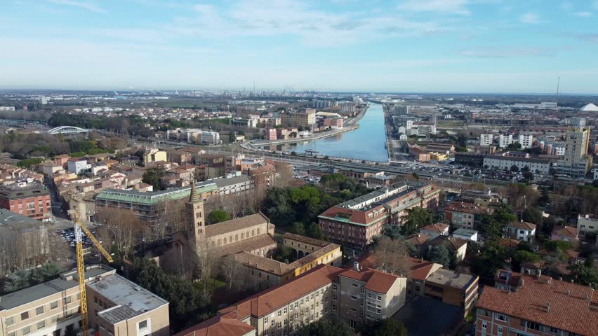Aerial drone footage of Ravenna, a historic city in Emilia-Romagna, Italy, known for its ancient churches, mosaics, and UNESCO World Heritage Sites under warm light and clear skies.