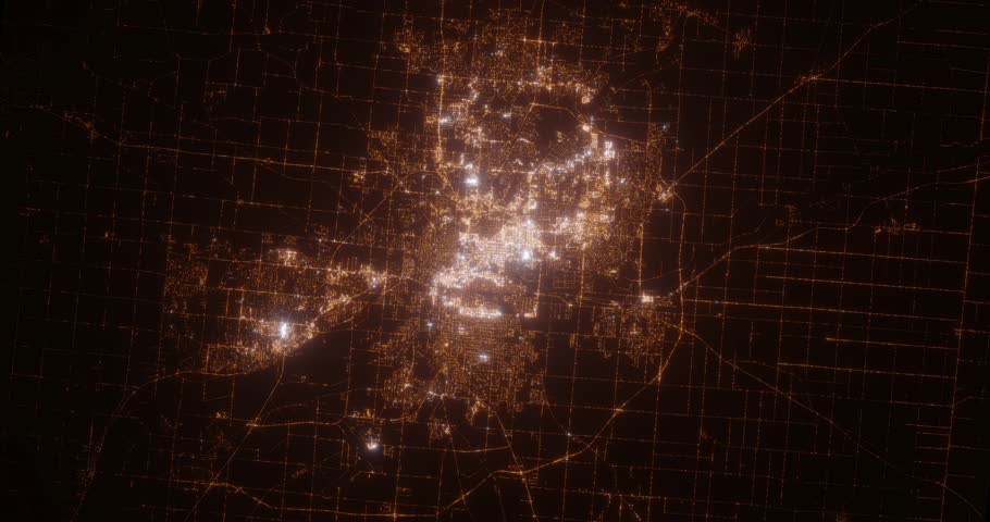 Fort Wayne (Indiana, USA) aerial view at night. Top view on city from space. Camera is zooming in, rotating clockwise