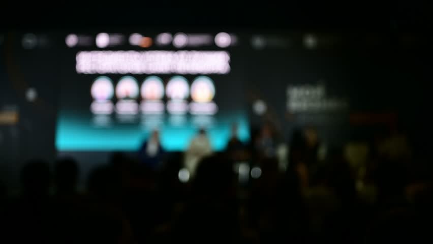 Engaged audience at tech conference keynote exploring ai and blockchain innovations