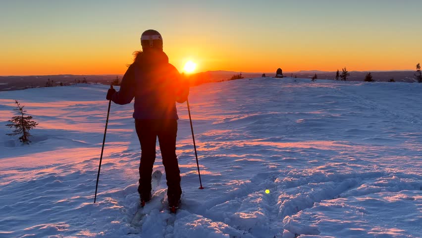 Norwegian winter sunset Telemark cross country ski skate turn Alpine skier skiing top of Hafjell Alpine resort Øyer mountain Norway Norge golden hour Lillehammer frigid frozen cold winter powder snow