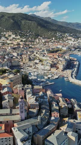 Aerial perspective of Corsica, France showcasing city buildings against the backdrop of the ocean.
