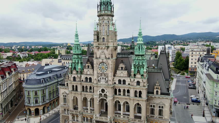 Aerial cinematic orbit of historic Liberec Town Hall with cloudy summer sky