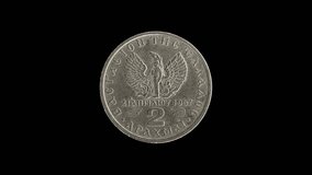 Greece 1967 two drachma coin reverse with phoenix rising from flames design rotating on black background - Powered by Shutterstock - Get 15% off with code: PIKWIZARD15