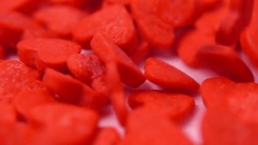 delightful visualization of red heart shaped candies falling on soft pink backdrop, ideal for wedding videos, love stories and sweet themes, concept St Valentine day, super slow motion - Powered by Shutterstock - Get 15% off with code: PIKWIZARD15