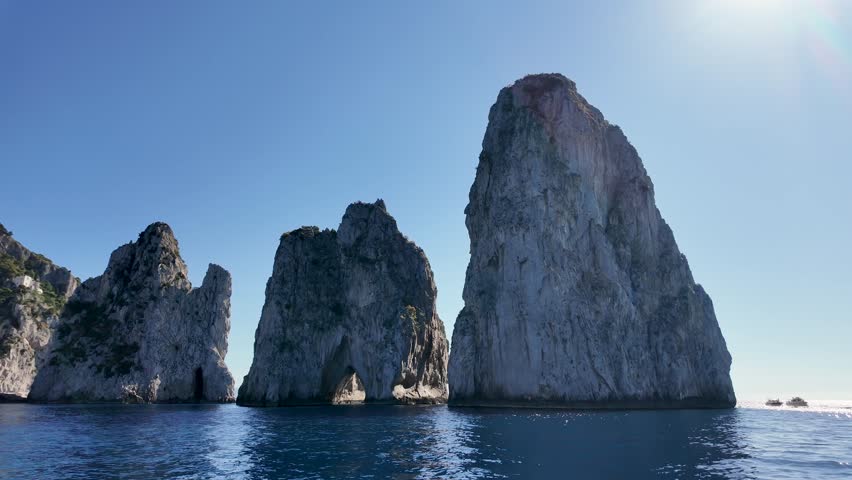 Faraglioni Island At Capri In Naples Italy. Beach Landscape. Giant Cliffs Scene. Faraglioni Island At Capri In Naples Italy. Gulf Of Naples Skyline. Mediterranean Sea Coast. Scenic Capri Island.