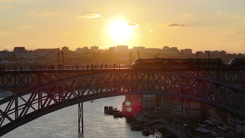 Sunset Dom Luis I Bridge At Porto In District Of Porto Portugal. Sunset Skyline Scene. Illuminated Bridge Landscape. Dom Luis I Bridge At District Of Porto Portugal. Railroad Transport.