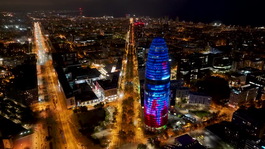 Night Skyline Of Glories Tower At Barcelona In Catalonia Spain. Night City Landscape. Financial District. Glories Tower At Catalonia Spain. Highrise Buildings Scenery.