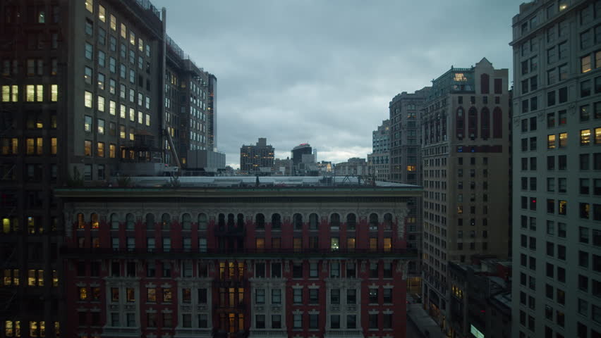 New York City skyline lighting up, office windows glimmering, Manhattan