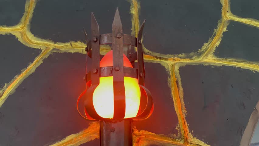 Medieval Wall Torch Light with Fiery Glow and Stone Background