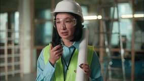 Asian woman builder engineer architect building industry answer walkie talkie radio remote control Chinese Japanese Korean female girl in hard hat technician foreman developer handyman factory build - Powered by Shutterstock - Get 15% off with code: PIKWIZARD15