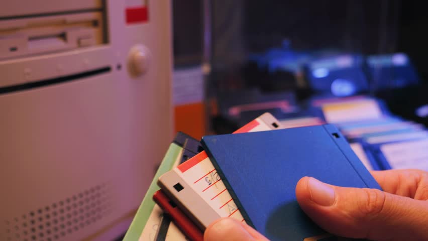 Floppy disc FDD close up, Using diskette for old PC computer macro. Archive programme or Music recorder, playing retro computer games. Vintage device for office, obsolete technology. 
