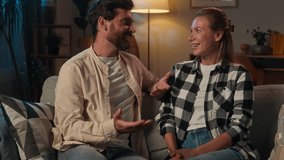 Caucasian affectionate couple love date relationship man woman boyfriend girlfriend wife husband girl guy homeowners family talking casual conversation story speaking on couch sofa evening night home - Powered by Shutterstock - Get 15% off with code: PIKWIZARD15