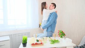 Love couple hugging cooking a meal together in the kitchen at home - Powered by Shutterstock - Get 15% off with code: PIKWIZARD15