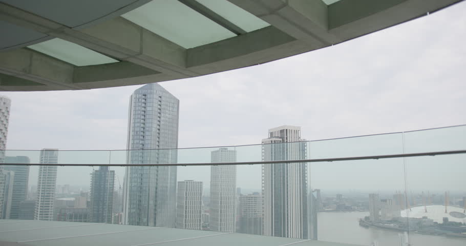 Businessman in Suit Walking on Office Rooftop Looking out over City Skyline