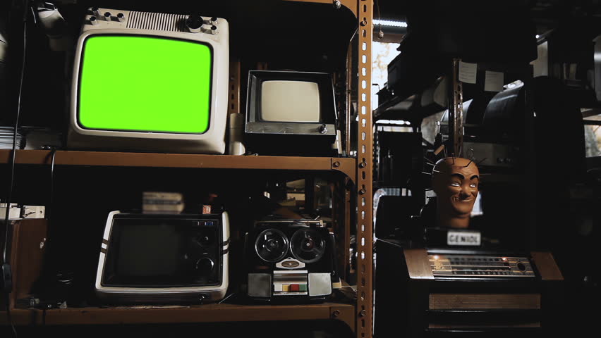Vintage Analog TV Set Turning On Green Screen Display, Surrounded by Old Technology in an Antique Store - Not AI-Generated - 4K	