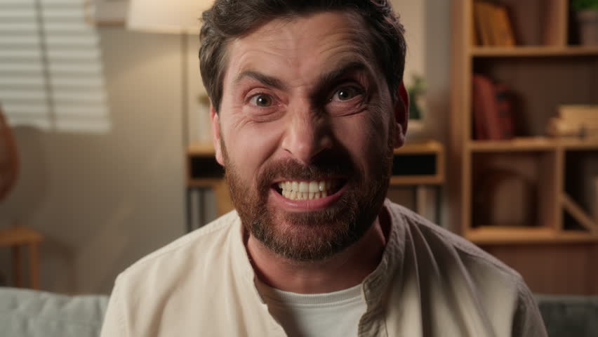 Irritated angry mad furious man Caucasian homeowner annoyed aggressive guy male businessman shouting screaming at camera crazy insane yelling negative emotions force expression scream problem at home