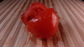 Tomato in half. Cut the cherry tomatoes in slow motion with a knife on a wooden board. Cutting vegetables with a top view. Slow motion cooking video. Fresh italian recipe with tomato juice - Powered by Shutterstock - Get 15% off with code: PIKWIZARD15