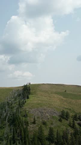 Majestic British Columbia Landscape with Rolling Green Hills and Distant Mountain Ranges