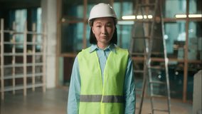 Asian woman builder Chinese girl engineer in vest hard hat thumb up gesture Korean Japanese female architect foreman inspector developer approval construction safety regulations work building industry - Powered by Shutterstock - Get 15% off with code: PIKWIZARD15