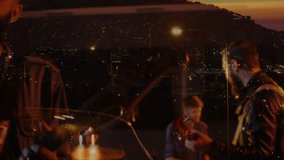music band playing on roof as city lights emerge vocalist singing while strumming and keeping beat. Concert, urban, nightlife, performance, melody, rhythm, harmony - Powered by Shutterstock - Get 15% off with code: PIKWIZARD15