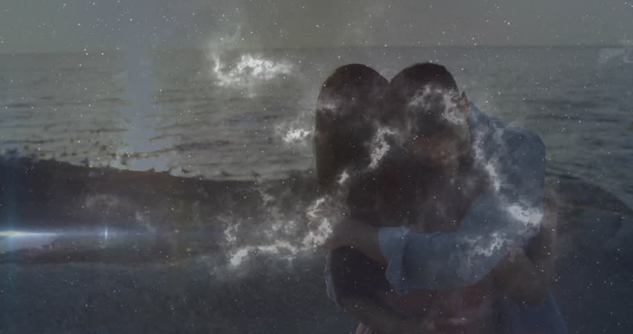 Man lifting woman on shore sparking swirling nebula enveloping couple in technology demo at sunset. Romantic, intimacy, celestial, ambient, fantastical, digital, ethereal