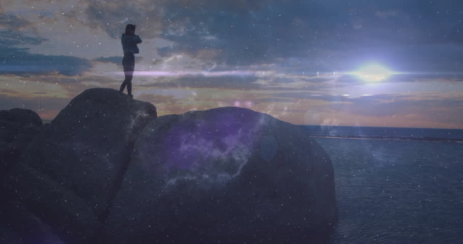 Woman climbing rocks as sun dipping horizon causing technology overlay pulling phone taking call. Coastline, solitude, adventure, twilight, celestial, exploration, wilderness