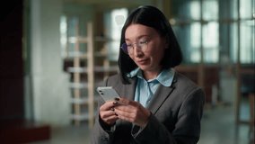 Happy smiling Asian woman Chinese businesswoman architect business employer texting mobile phone message scrolling social media addict Korean Japanese female girl user smartphone online work in office - Powered by Shutterstock - Get 15% off with code: PIKWIZARD15