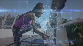 woman stepping onto railing and securing running shoe as holographic globe displaying data for run. Athletic, urban, futuristic, technology, fitness, outdoor, determination - Powered by Shutterstock - Get 15% off with code: PIKWIZARD15