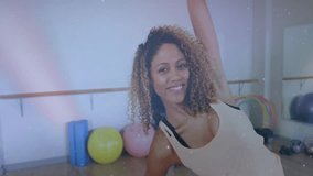 Fitness instructor raising right arm initiating side stretch at barre with students mirroring pose. Wellness, flexibility, exercise, studio, health, posture, stretching - Powered by Shutterstock - Get 15% off with code: PIKWIZARD15