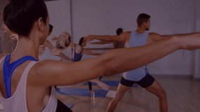 Instructor cueing warrior II in fitness class, students adjusting alignment with floating glitter. Meditation, wellness, fitness, harmony, mindfulness, serenity, stretching - Powered by Shutterstock - Get 15% off with code: PIKWIZARD15