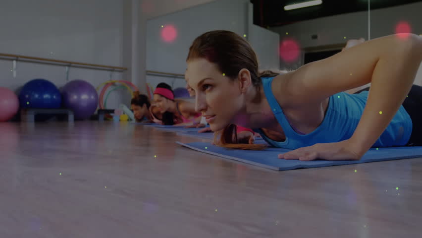 Instructor cuing participants doing fitness push-ups on mats with animated light trails swirling. Fitness, group, exercise, wellness, animation, motivation, sport - Powered by Shutterstock - Get 15% off with code: PIKWIZARD15