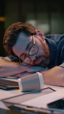 Caucasian guy sleeping tired businessman sleep nap at dark night office lost health problem insomnia overtime male business man workaholic overworked exhausted awake stressed typing computer deadline