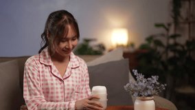 Young Asian woman uses an aromatherapy diffuser with essential oils at home to create a calming relaxing atmosphere for wellness and longevity lifestyle at night. - Powered by Shutterstock - Get 15% off with code: PIKWIZARD15
