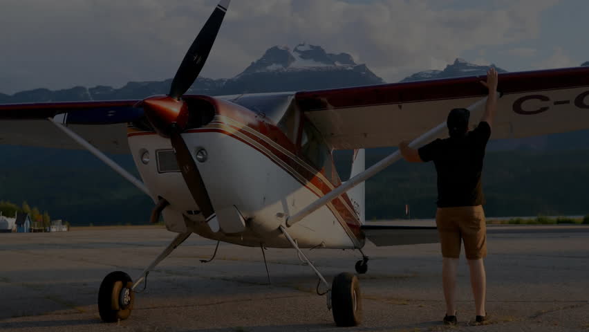 Pilot walking to plane at airfield, inspecting wing, opening cockpit, climbing, doing flight checks. Aviator, aviation, adventure, travel, aircraft, scenic, outdoors