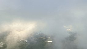 A cinematic drone shot pulls back just beneath a layer of dramatic, moody clouds, revealing majestic sunbeams, crepuscular rays breaking through to illuminate vast green forest and lakes of Latvia. - Powered by Shutterstock - Get 15% off with code: PIKWIZARD15
