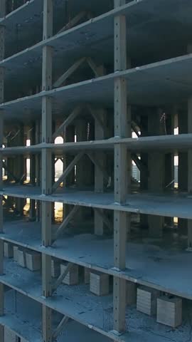 Observers can see the ongoing construction of a high-rise building in a city. The structural framework is taking shape, showcasing concrete and steel elements in use.