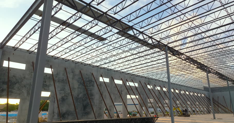 Warehouse construction. Concrete and metal structure of industrial building. Frame of modern logistic center.