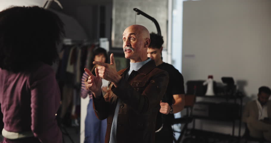 Art, group and movie slate for filming, direction or videography in studio, creative and production. Media, team and director with advice for actor, people and videographer with camera for shoot
