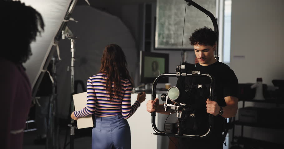 Art, group and movie slate for filming, direction or videography in studio, creative and production. Media, team and director with advice for actor, people and videographer with camera for shoot