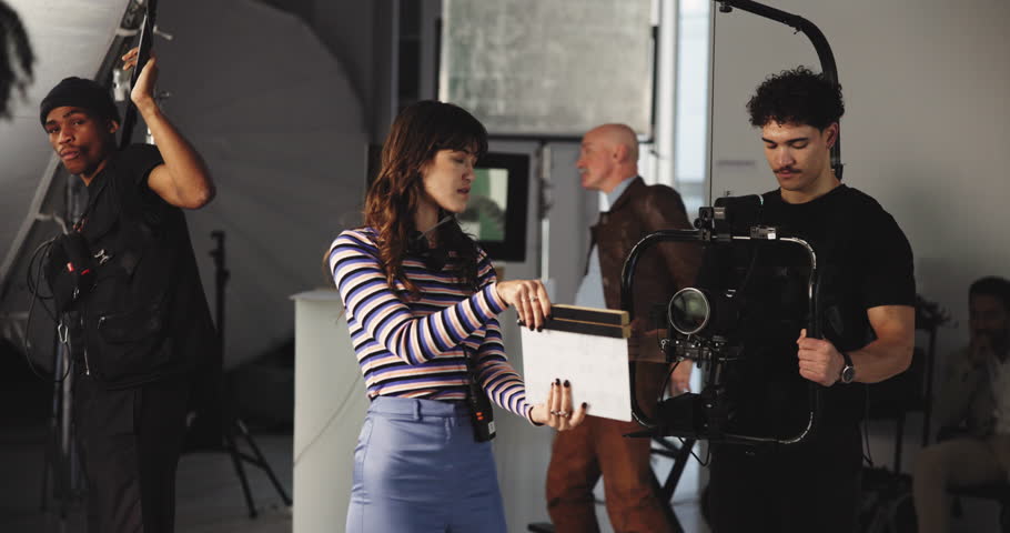 Team, people and movie slate for shoot, actor and process in studio, production or behind the scene. Media, group and videographer with camera for filming, creative and filmmaker with equipment