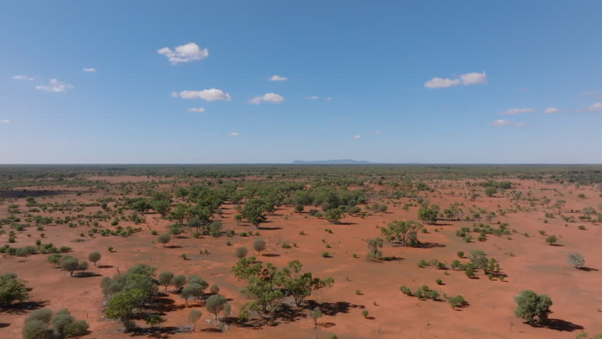 Aerial: Drone shot of Mount Gunderbooka on the horizon in the Australian outback near Bourke,