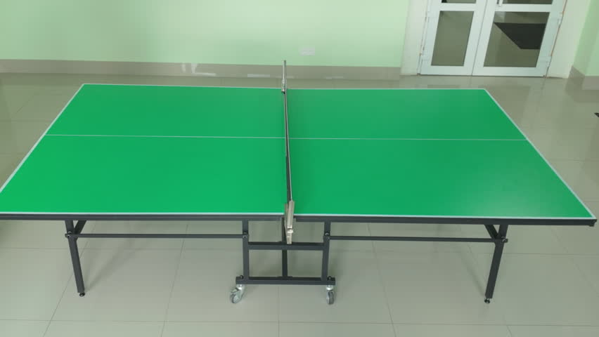 Video footage of two people playing competitive ping pong game on bright green table tennis surface. - Powered by Shutterstock - Get 15% off with code: PIKWIZARD15