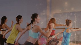 Center instructor initiating fitness routine at mirrored barre guiding group performing knee lifts. Group exercise, dance fitness, workout session, wellness, professional training, dynamic movement, - Powered by Shutterstock - Get 15% off with code: PIKWIZARD15