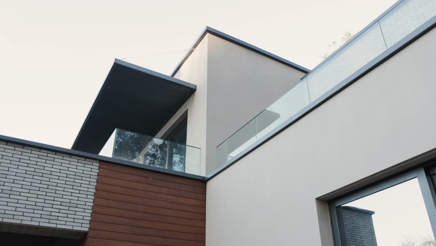 Modern architecture: house design with glass elements, large windows, tiles, wood and brick